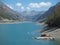 Drone aerial view of the Lake Livigno with with pedal boats. Italian Alps. Italy