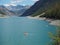 Drone aerial view of the Lake Livigno with with pedal boats. Italian Alps. Italy