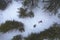 Drone aerial of woman wearing warm clothing lie down at snow in winter. Troodos cyprus