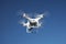 Drone on blue sky background. Remote control quadrocopter with camera for photography. Flying robot