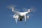 Drone on blue sky background. Remote control quadrocopter with camera for photography. Flying robot