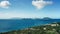 Drone camera captures a white yacht in front of a city in rainforest Saint Kitts and Nevis