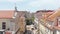 Drone camera flying forwards above Rua Garrett street. Aerial view of principal shopping street in Chiado. Lisbon