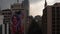 Drone camera flying forwards between tall office buildings in city downtown. Sky before heavy rain. Mexico city, Mexico.