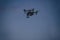 Drone with a camera flying in night sky. Spying with quadcopter