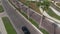 Drone camera follows black sport car on the street with palm trees