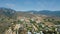 Drone camera shoots the canyon and the settlement at the foot of the mountain on a clear sunny day