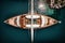 A drone captures the view of a wooden deck yacht docked in the Aegean Sea from above. AI