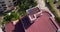 Drone Circling view of the red roof with solar panels