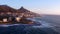 Drone, city and beach with buildings or waves and sunshine with vacation landscape and Cape Town. Travelling, ocean and