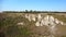 Drone closing up on a mountainside, rocky hill with the cliff.