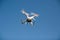 Drone copter with the camera flies in the blue sky