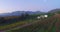 Drone, countryside and landscape of farm, vineyard and mountains by blue sky in Italy. Aerial view, agriculture and
