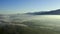 Drone, countryside and misty environment in nature, landscape and sustainability in outdoors. Aerial view, foggy and