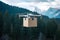 Drone delivers goods over forested mountains in cardboard box