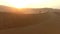 Drone, desert or man travel in Dubai for sunset, nature beauty on dry land, horizon or Africa sahara. Hill, earth or