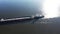 Drone drone shooting around an empty barge going to the port loading in a tugboat