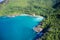 Drone field of view of secret cove with turquoise blue water meeting the forest on secluded island of Mahe, Seychelles