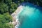 Drone field of view of secret cove with turquoise blue water meeting the forest on secluded island of Mahe, Seychelles