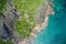 Drone field of view of spectacular blue coastline with waves and forest on Curieuse Island, Seychelles