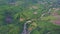 Drone Flies above Long Creek Running among Wild Hilly Jungles