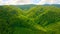 Drone flies above mountains covered fresh foliage