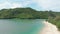 Drone flies along Aerial shot camera takes off over a deserted sandy beach of a tropical islempty sandy beach on a tropical island