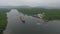 A drone flies along a large red cargo ship