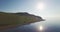 Drone flies along the stony shore o a Baikal lake