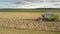 Drone flies close to modern harvester cutting wheat stems