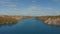 Drone flies over the blue river. Beautiful landscape with a meander river. Flying over a blue lake. Wild nature scene