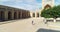 A drone flies over a group of tourists in the courtyard of an ancient complex Ulugbek Madrasah. Old Bukhara, Uzbekistan.