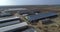 drone flies over large farm with hangars and warehouses, top view of cowsheds and agricultural fields