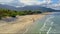 Drone flies over people searching on sand beach edge