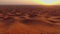 A drone flies over quad bikes driving through the sand dunes of the desert in the United Arab Emirates