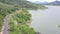 Drone Flies Over the Road near the lake and mountain on Which Racing Driver Driving a Sports Atv