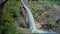 Drone Flies over Waterfall Lake Rocks with Tree on Foreground