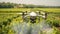 drone flies and sprays green plants in the beds irrigation equipment agriculture