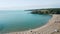 Drone flight above an empty sandy beach