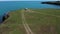 Drone flight above a picturesque coastline with camper car