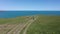 Drone flight above a woman at picturesque coastline