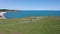 Drone flight above a woman at picturesque coastline