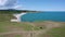 Drone flight above a woman at picturesque coastline