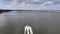 Drone flight behind a boat over the Volga river on a sunny April day