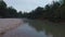 Drone flight in the evening over the surface of the river in the countryside