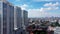 Drone flight forward. Aerial View of Jakarta Downtown Skyline with High-Rise Buildings With White Clouds and Blue Sky