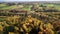 Drone flight over fall colours towards golf course