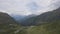 Drone flight over a high alpine mountain road pass.