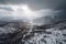 drone flight over snowy mountain range, with dramatic storm clouds in the background