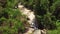 Drone flight over a waterfall in the tropical rainforest jungle on summer day.